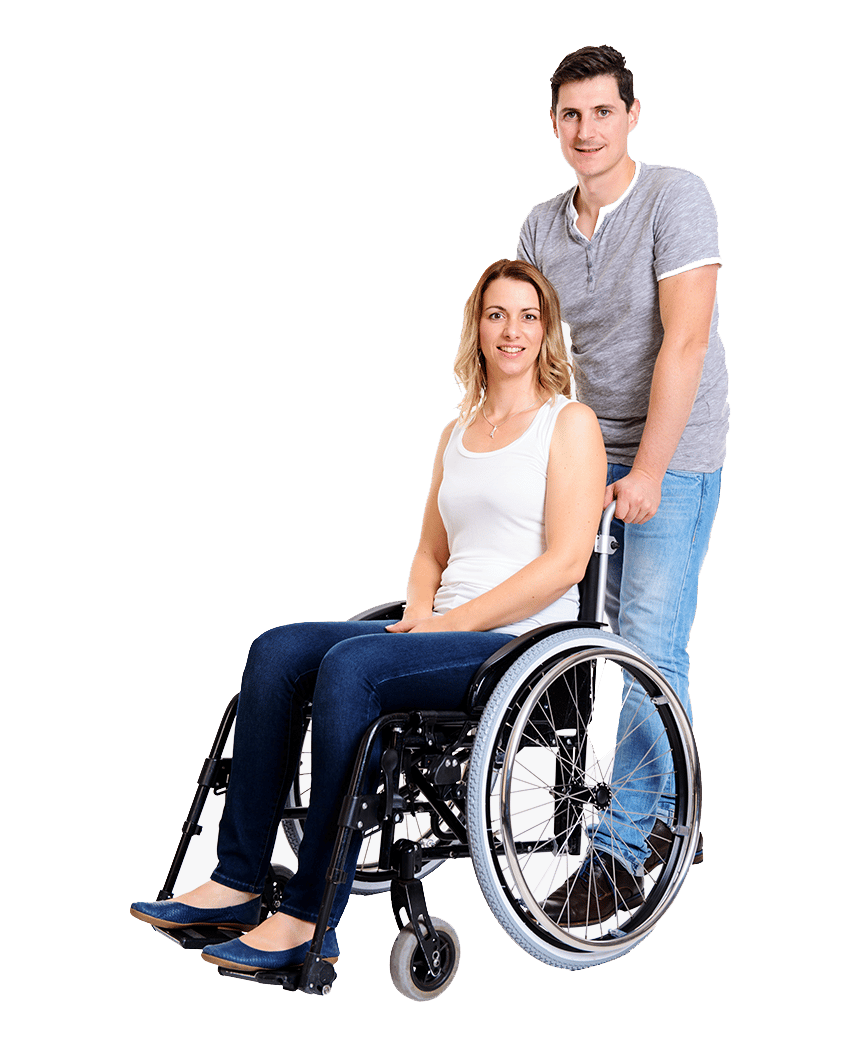 A woman in a wheelchair assisted by a carer
