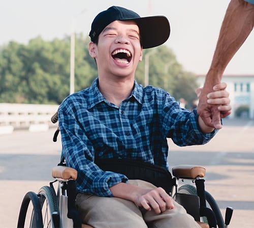 Happy Kid in Wheelchair — Disability Care Services in Kingswood, NSW